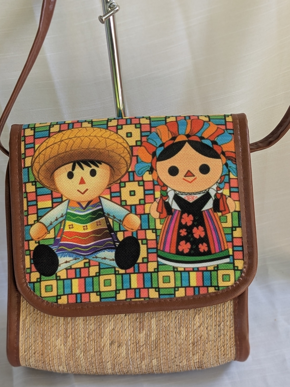 handcrafted Mexican artisan crossbody purse featuring embroidered doll designs